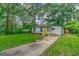 Exterior of house with light grey siding, yellow door and long driveway at 1024 Regis Rd, Atlanta, GA 30315