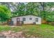Back exterior view of house featuring dark grey trim, small deck, siding, and AC unit at 1024 Regis Rd, Atlanta, GA 30315