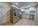 Updated kitchen with stainless appliances, white cabinets, granite counters, and sleek modern flooring at 1024 Regis Rd, Atlanta, GA 30315