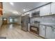 Modern kitchen with stainless appliances, granite countertops, white cabinetry, and sleek modern flooring at 1024 Regis Rd, Atlanta, GA 30315