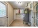 Bright laundry room with updated cabinets, light wood flooring, and water heater at 1024 Regis Rd, Atlanta, GA 30315