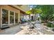 Enjoy a stone patio, outdoor dining set, and covered lounge area for perfect relaxation at 117 Via Roma, Woodstock, GA 30188
