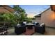Outdoor patio seating area with a fire pit and surrounding trees at 117 Via Roma, Woodstock, GA 30188