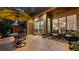 Outdoor patio featuring stone flooring, outdoor furniture, and view into the home's interior at 117 Via Roma, Woodstock, GA 30188