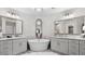 Bright bathroom featuring a standalone tub, dual vanities, and modern mirrors at 117 Via Roma, Woodstock, GA 30188