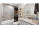Chic bathroom with tub-shower combo, gray tile, and granite vanity for a relaxing experience at 117 Via Roma, Woodstock, GA 30188