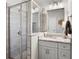 Updated bathroom features glass shower, granite countertops, and decorative mirror at 117 Via Roma, Woodstock, GA 30188