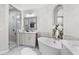 Elegant bathroom featuring soaking tub, walk-in shower, and marble-topped vanity at 117 Via Roma, Woodstock, GA 30188