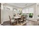 Charming dining room with a chandelier, large windows, and ample space for entertaining guests at 117 Via Roma, Woodstock, GA 30188