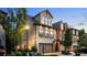 Stunning exterior of a well-maintained townhome featuring stone accents, manicured landscaping, and a private two-car garage at 117 Via Roma, Woodstock, GA 30188