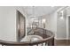 Stairway with curved wood railing and modern chandelier at 117 Via Roma, Woodstock, GA 30188