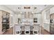 Spacious kitchen featuring grey cabinets, stainless steel appliances, marble countertops and a large island at 117 Via Roma, Woodstock, GA 30188