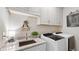 Bright laundry room with granite countertops, modern sink, and appliances at 117 Via Roma, Woodstock, GA 30188