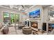 Inviting living room featuring a fireplace, coffered ceiling, and access to the outdoor patio through glass doors at 117 Via Roma, Woodstock, GA 30188