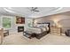 Spacious bedroom with fireplace, tray ceilings, and soft natural light at 117 Via Roma, Woodstock, GA 30188