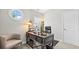 Cozy office space with wooden desk, chair, and natural light at 117 Via Roma, Woodstock, GA 30188