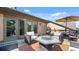 Relaxing patio with stylish outdoor furniture, fire pit, and open views at 117 Via Roma, Woodstock, GA 30188