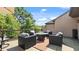 Expansive outdoor patio features comfortable seating, a fire pit, and serene views of the landscape at 117 Via Roma, Woodstock, GA 30188