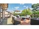 Serene outdoor patio with comfortable furniture, a fire pit, and beautiful green views at 117 Via Roma, Woodstock, GA 30188