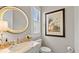 Stylish powder room with marble vanity, round mirror, and elegant fixtures at 117 Via Roma, Woodstock, GA 30188
