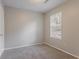 Cozy bedroom featuring plush carpet and a sunlit window with blinds at 8670 Brandon Hill Ln, Jonesboro, GA 30238