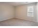 Bedroom featuring neutral carpet, paint, and window at 8670 Brandon Hill Ln, Jonesboro, GA 30238