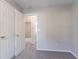 Bedroom with neutral carpet, paint, and large closet with white doors at 8670 Brandon Hill Ln, Jonesboro, GA 30238