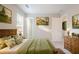 Serene bedroom featuring a rustic wooden headboard, soft green bedding, and natural light at 8670 Brandon Hill Ln, Jonesboro, GA 30238