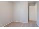 Bedroom features neutral carpet and paint with a door at 8670 Brandon Hill Ln, Jonesboro, GA 30238
