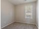This bedroom has neutral paint and a window with blinds at 8670 Brandon Hill Ln, Jonesboro, GA 30238