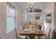 Bright dining room features stylish chandelier, wood table and staircase in the background at 8670 Brandon Hill Ln, Jonesboro, GA 30238