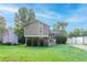 Charming two-story home featuring mature trees, inviting front porch, and a lush green lawn at 8670 Brandon Hill Ln, Jonesboro, GA 30238