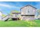 A wide view of the backyard and home exterior showcasing a deck, two stories and manicured lawn at 8670 Brandon Hill Ln, Jonesboro, GA 30238