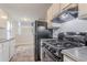 Bright kitchen with modern appliances, white cabinets, and views into adjacent living area at 8670 Brandon Hill Ln, Jonesboro, GA 30238
