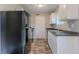 Functional kitchen featuring stainless steel appliances, gray countertops, and white cabinets at 8670 Brandon Hill Ln, Jonesboro, GA 30238