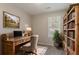 Cozy office space featuring a wooden desk, bookshelf, and a picturesque window view at 8670 Brandon Hill Ln, Jonesboro, GA 30238
