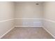 Neutral room with carpet, white trim, and an electrical outlet on the wall at 8670 Brandon Hill Ln, Jonesboro, GA 30238