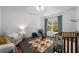 Bright and airy Bedroom with a cozy chair, patterned rug, and wooden crib at 106 Oakhurst Ter, Decatur, GA 30030
