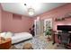 Bedroom with pink walls, work-from-home desk, and french doors leading to another room at 106 Oakhurst Ter, Decatur, GA 30030