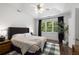 Serene main bedroom with tray ceiling, large windows, and stylish decor at 106 Oakhurst Ter, Decatur, GA 30030