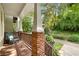 Relaxing covered porch with brick supports, wooden railings, and a comfortable chair at 106 Oakhurst Ter, Decatur, GA 30030