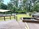 Backyard deck featuring tiered planting beds, sun shades, and lush green landscape at 1872 Canmont Ne Dr, Brookhaven, GA 30319