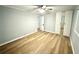 This bedroom features updated laminate flooring, light gray walls and a closet with mirrored doors at 1872 Canmont Ne Dr, Brookhaven, GA 30319