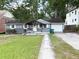 Charming single-story home with gray siding, a pergola-covered porch, and an attached one-car garage at 1872 Canmont Ne Dr, Brookhaven, GA 30319