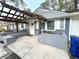 Inviting covered front porch with pergola, gray painted brick seating and an exterior door at 1872 Canmont Ne Dr, Brookhaven, GA 30319