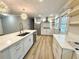 Modern kitchen featuring a large island, stainless steel appliances, white cabinetry, and open shelving at 1872 Canmont Ne Dr, Brookhaven, GA 30319