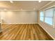 Bright open-concept room with modern flooring, light gray walls, and large windows offering ample natural light at 1872 Canmont Ne Dr, Brookhaven, GA 30319