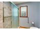 Walk-in shower with tile surround, glass doors, and a convenient grab bar in the bathroom at 220 Gamble Dr, Carrollton, GA 30116