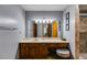 Bathroom vanity with a large mirror, updated lighting, and a tiled shower at 220 Gamble Dr, Carrollton, GA 30116
