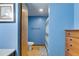 Blue bathroom with toilet, towel bar, and shower with curtains at 220 Gamble Dr, Carrollton, GA 30116